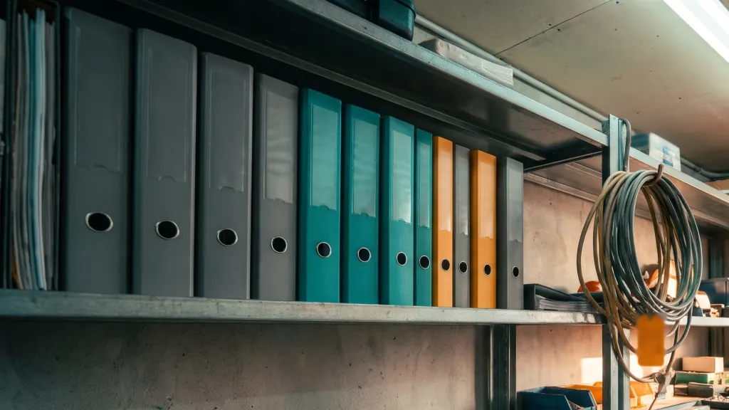 Binders of building records on an office shelf.